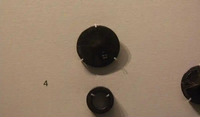 Prechristian cross on jet buttons and rings